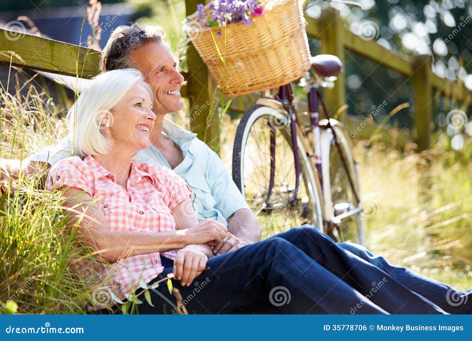 middle aged couple relaxing on country cycle ride