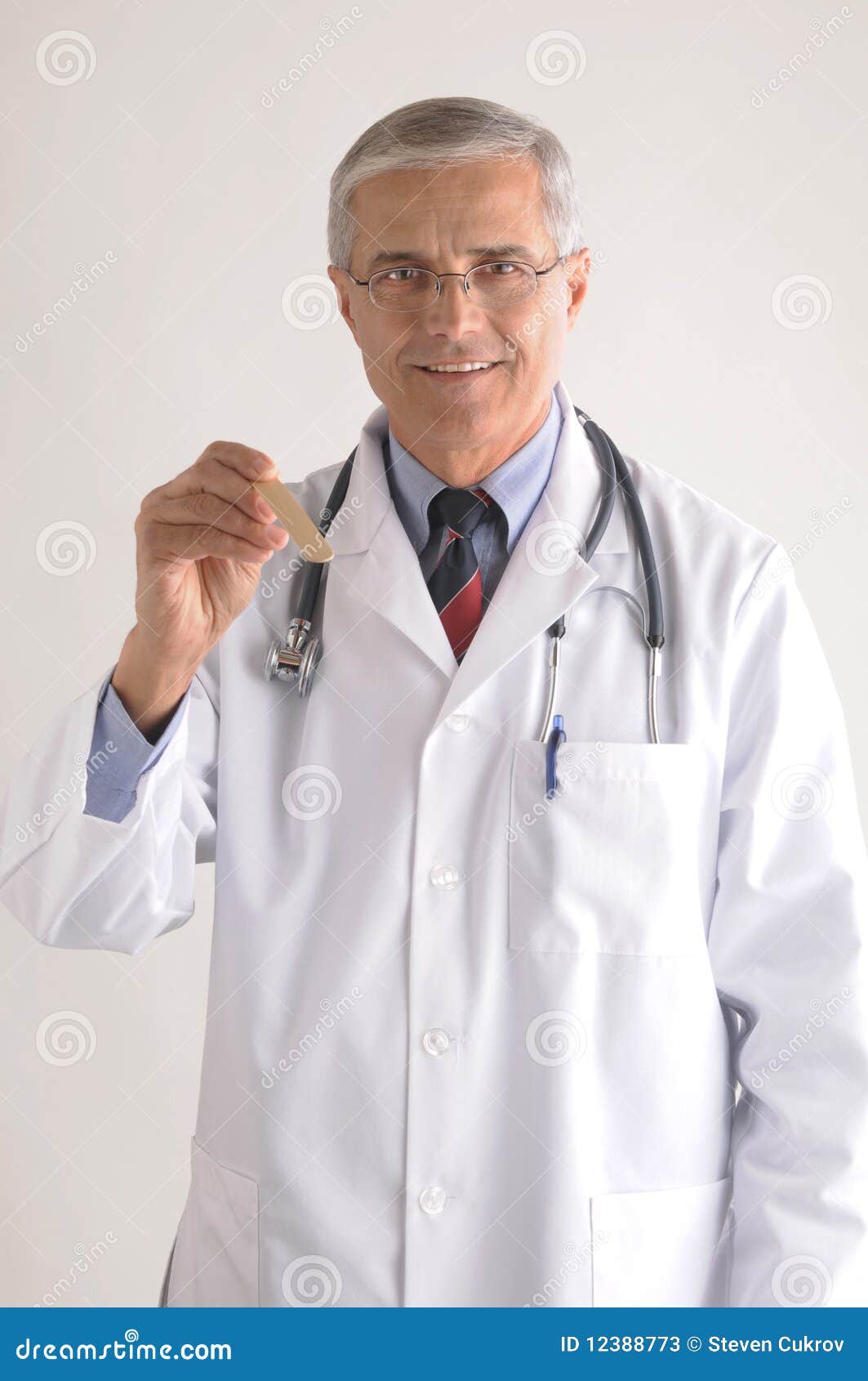 Middle Aged Doctor Labcoat With Tongue Depressor Stock Image Image of