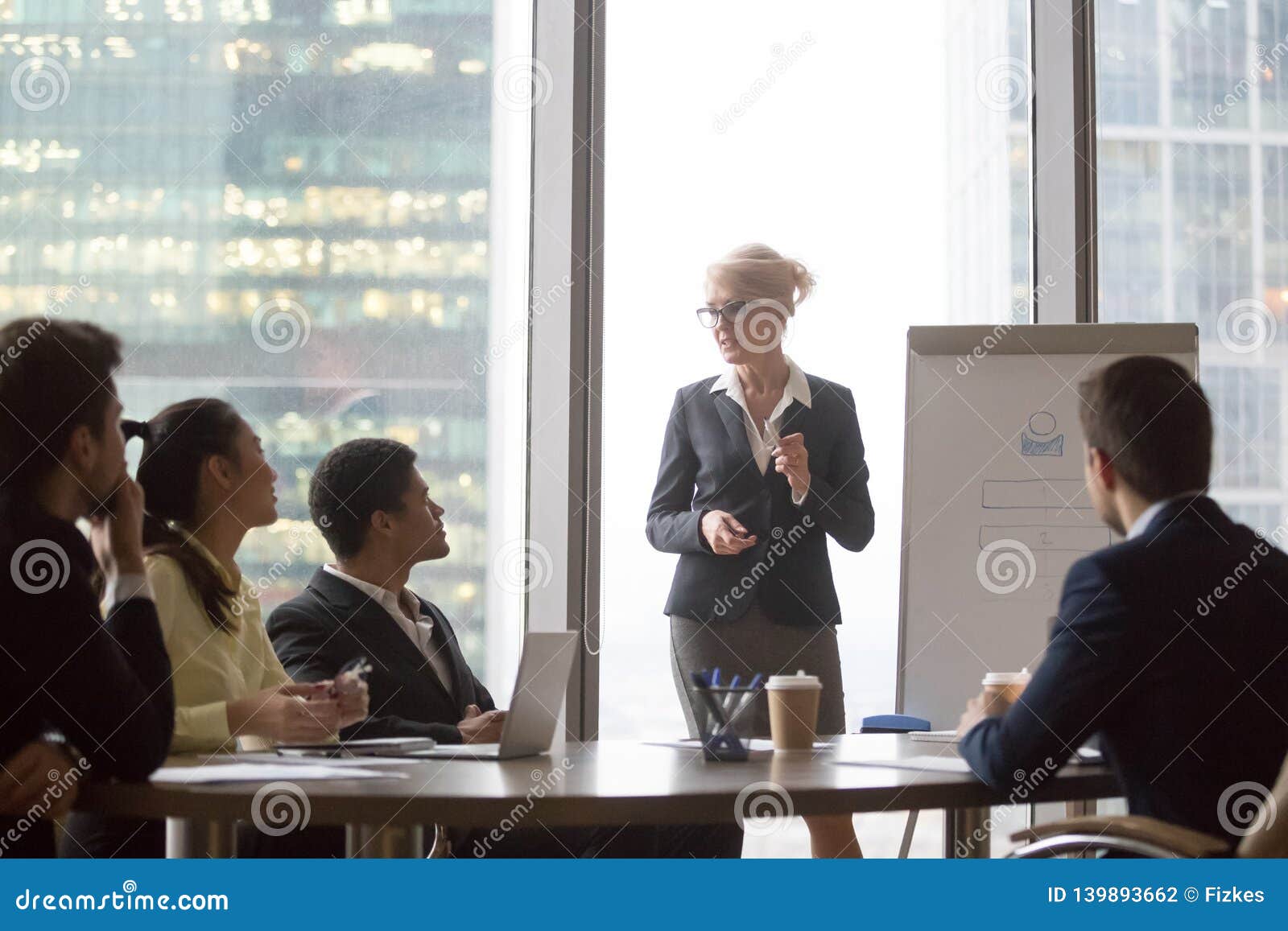 middle-aged executive give presentation lecture for diverse corporate team
