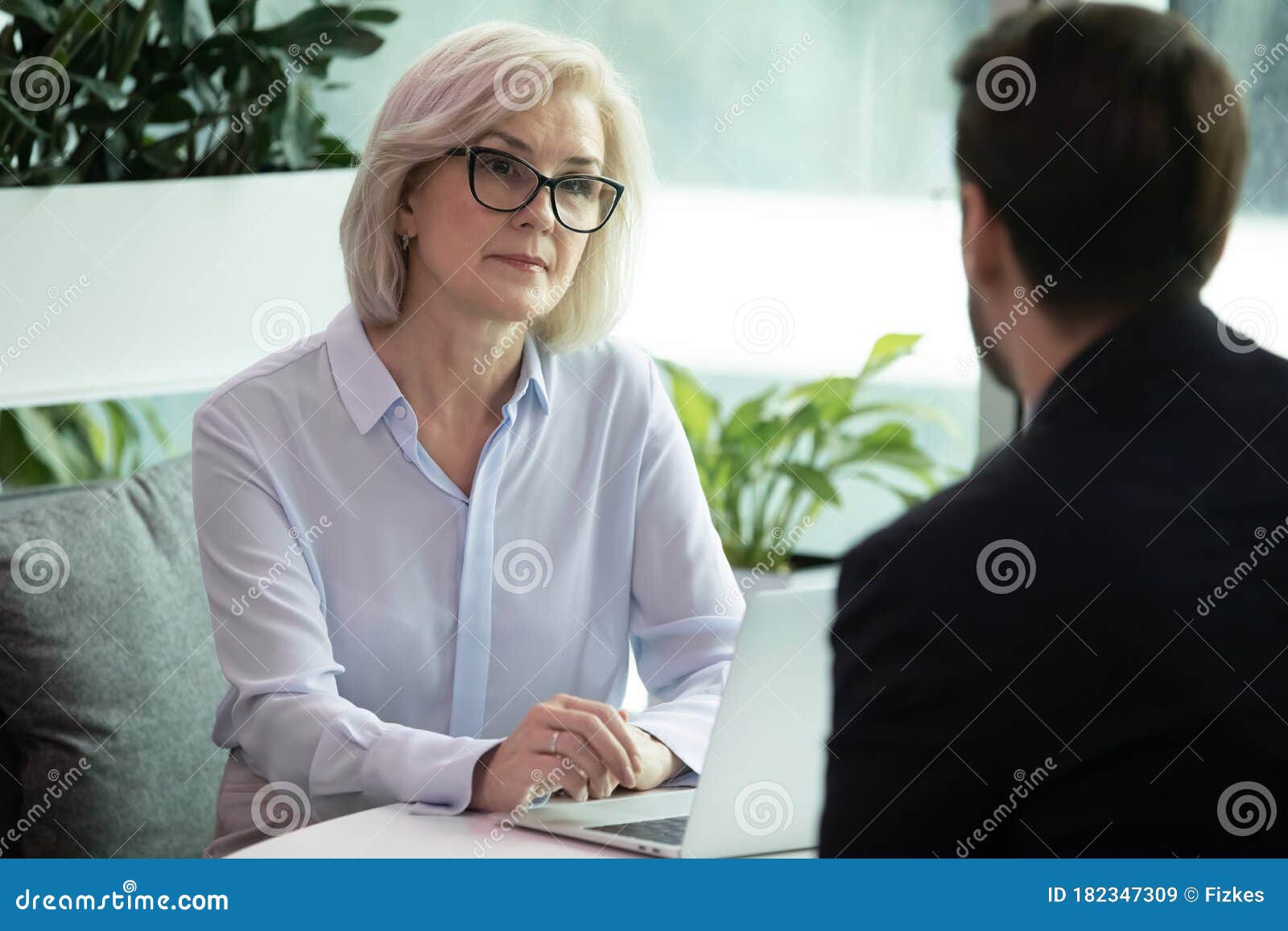 middle aged hr manager listen male applicant during job interview