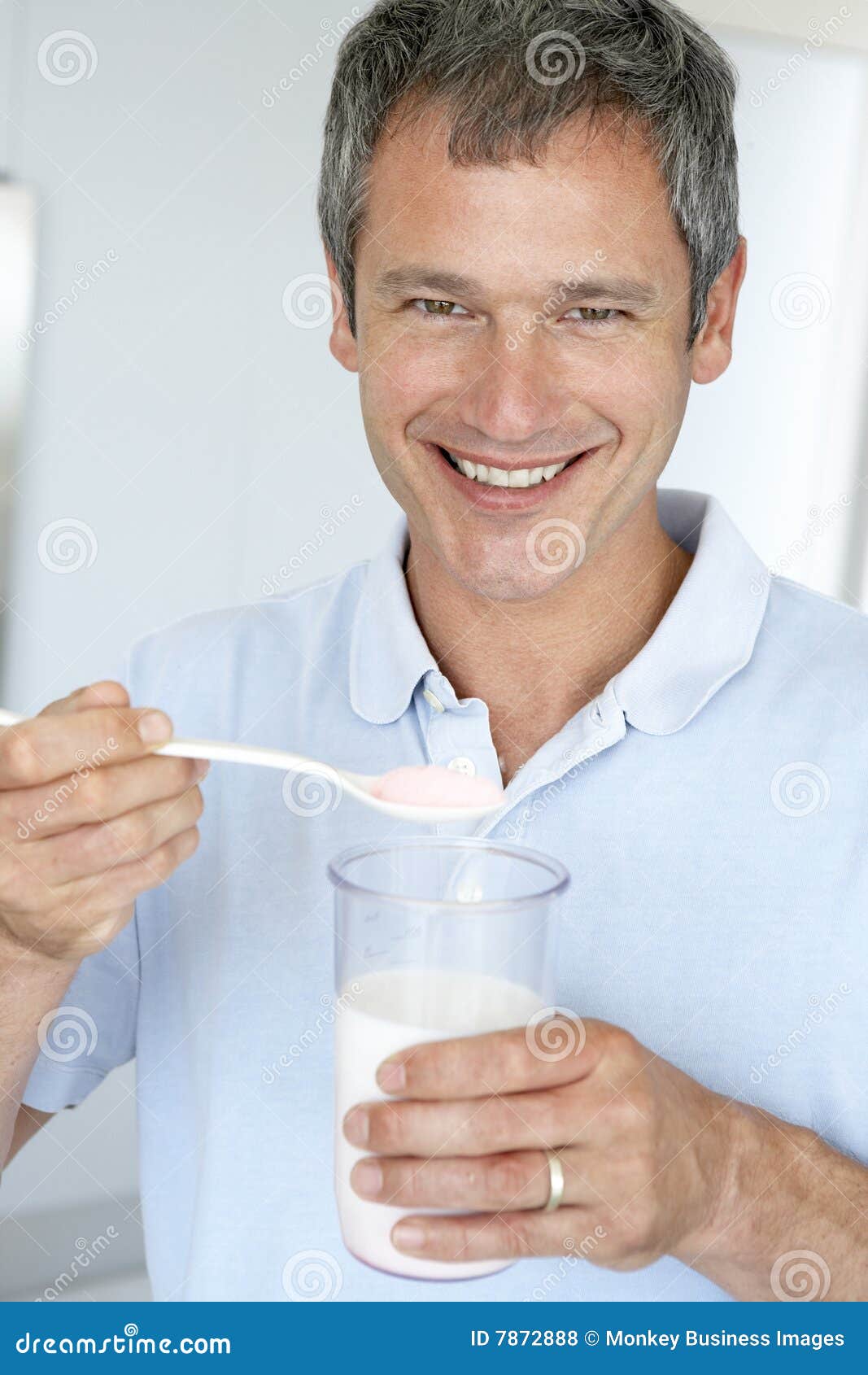 middle aged man holding dietary supplements