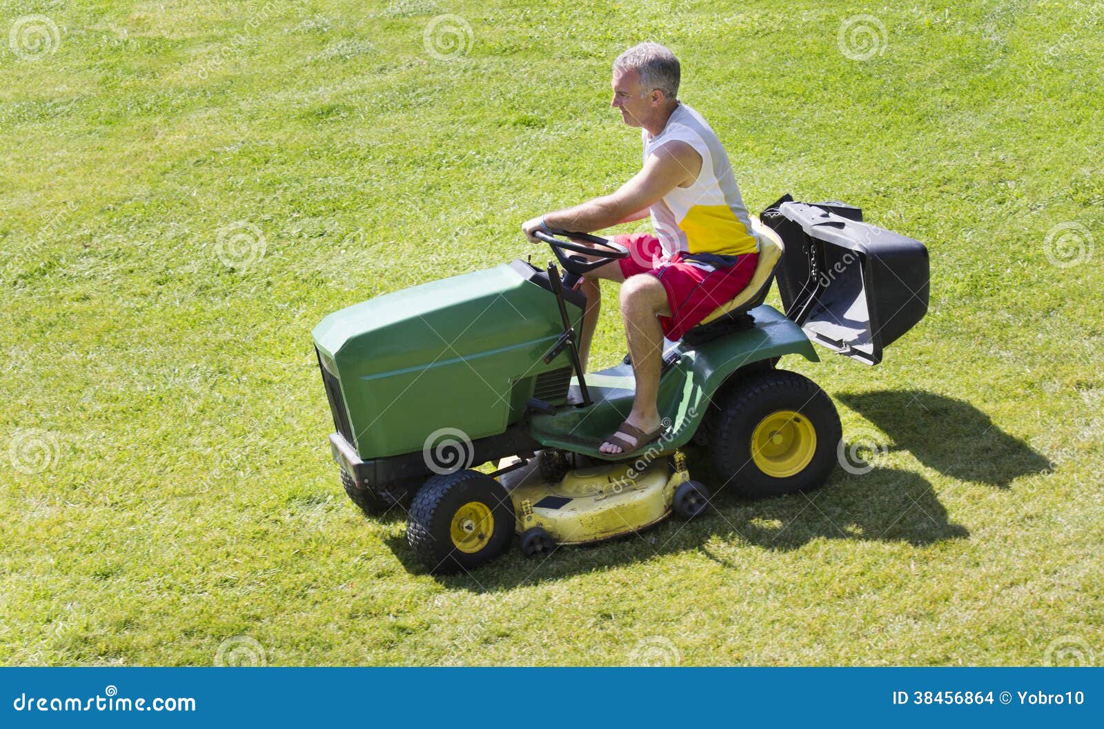 MiddleAged Man Mowing Lawn on Riding Mower Stock Photo Image of