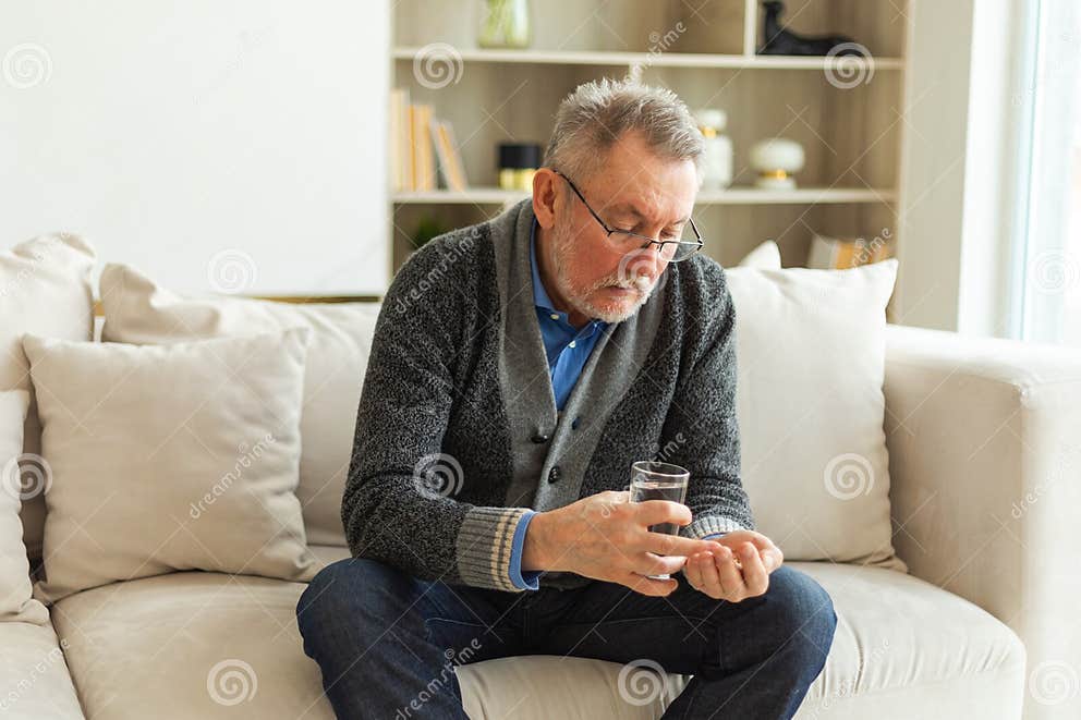 middle-aged-senior-man-holding-medical-pill-and-glass-of-water-mature