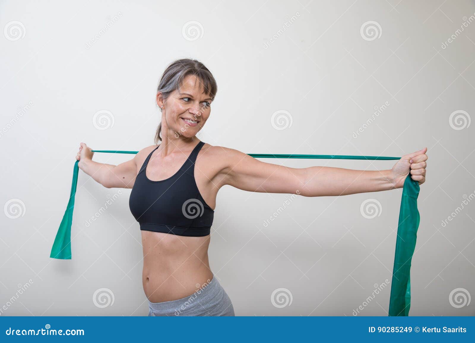 Middle-aged woman posing in bra and jeans stock photo (219986