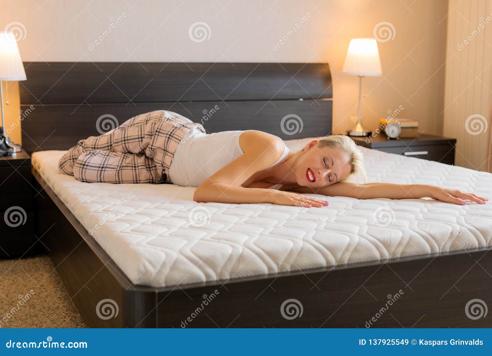 woman feeling happy about her new comfortable mattress