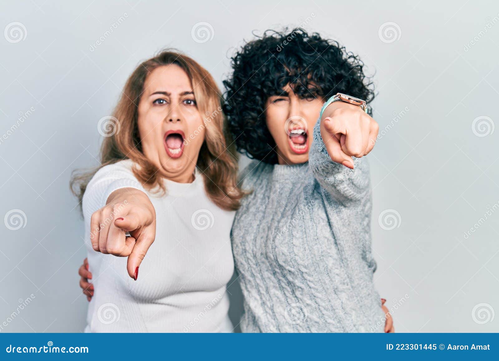 Middle East Mother and Daughter Wearing Casual Clothes Pointing