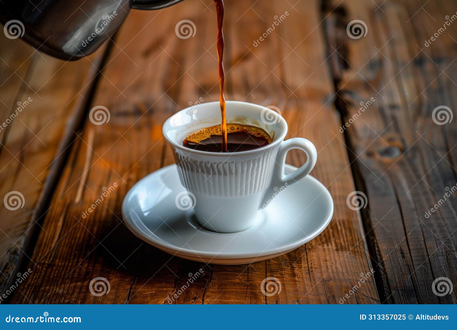 midpour shot of coffee into a cup with a saucer on a wooden table