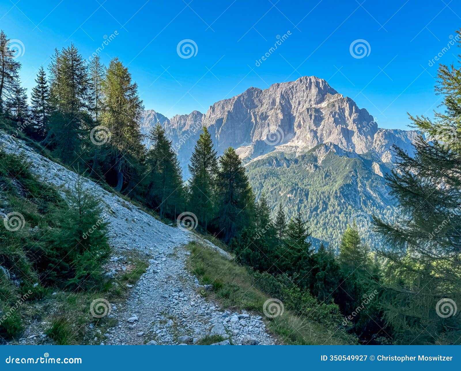 miezegnot - hiking trail towards mountain peak jof di miezegnot with scenic view of rugged massif jof di montasio
