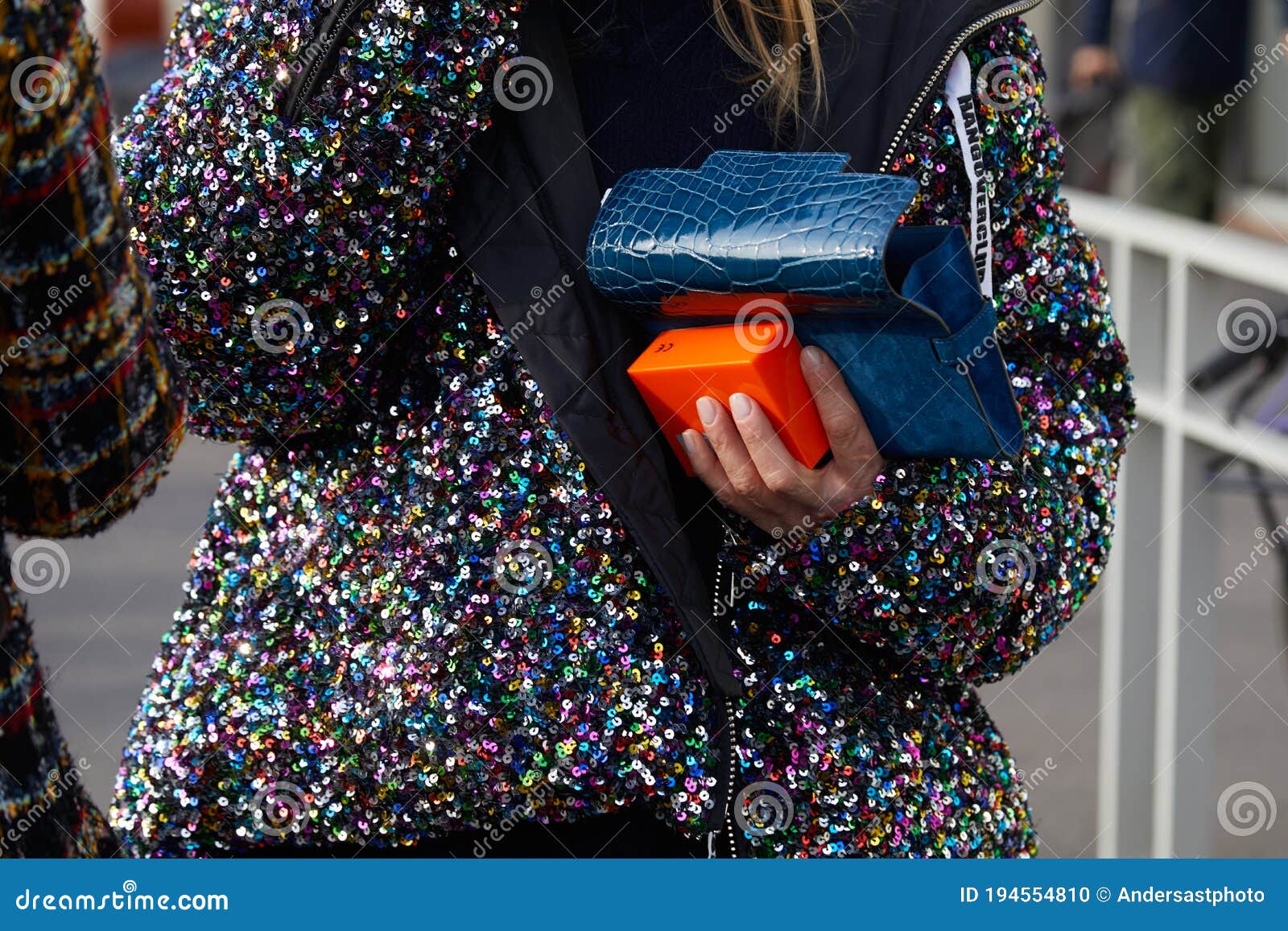 Woman with Colorful Sequin Jacket and Blue Crocodile Leather Bag