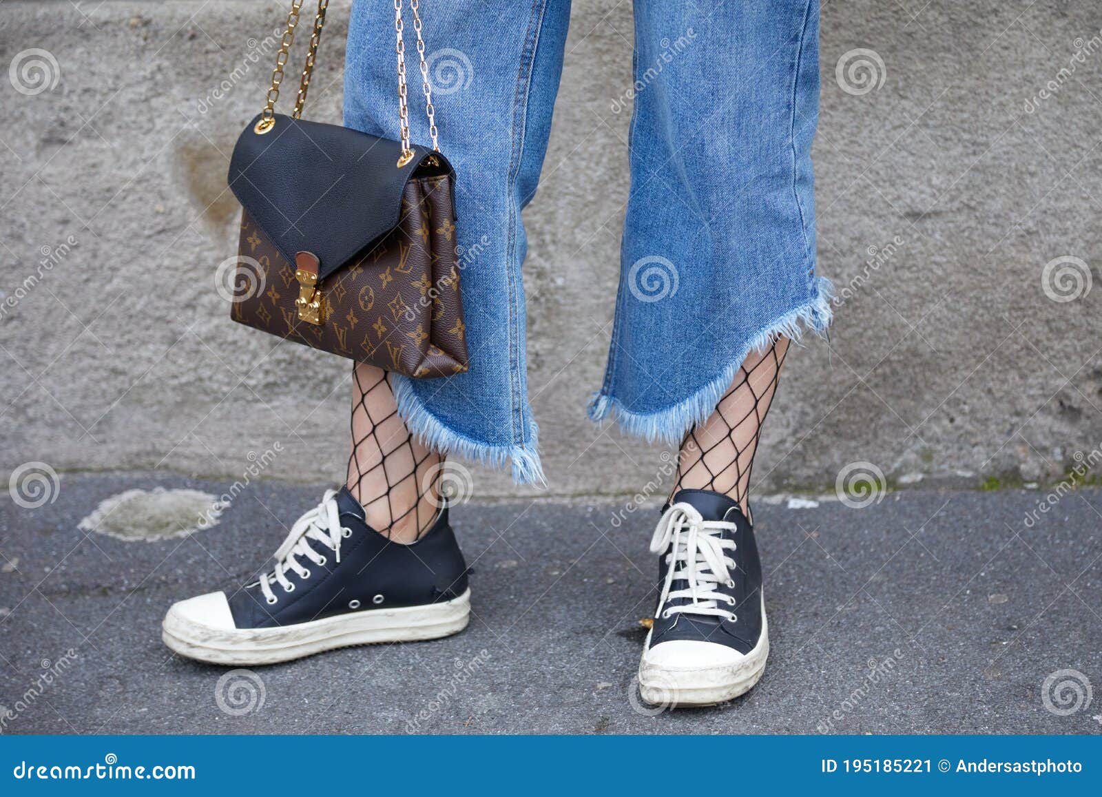 Woman with Louis Vuitton Bag and Torn Blue Jeans before Tod`s