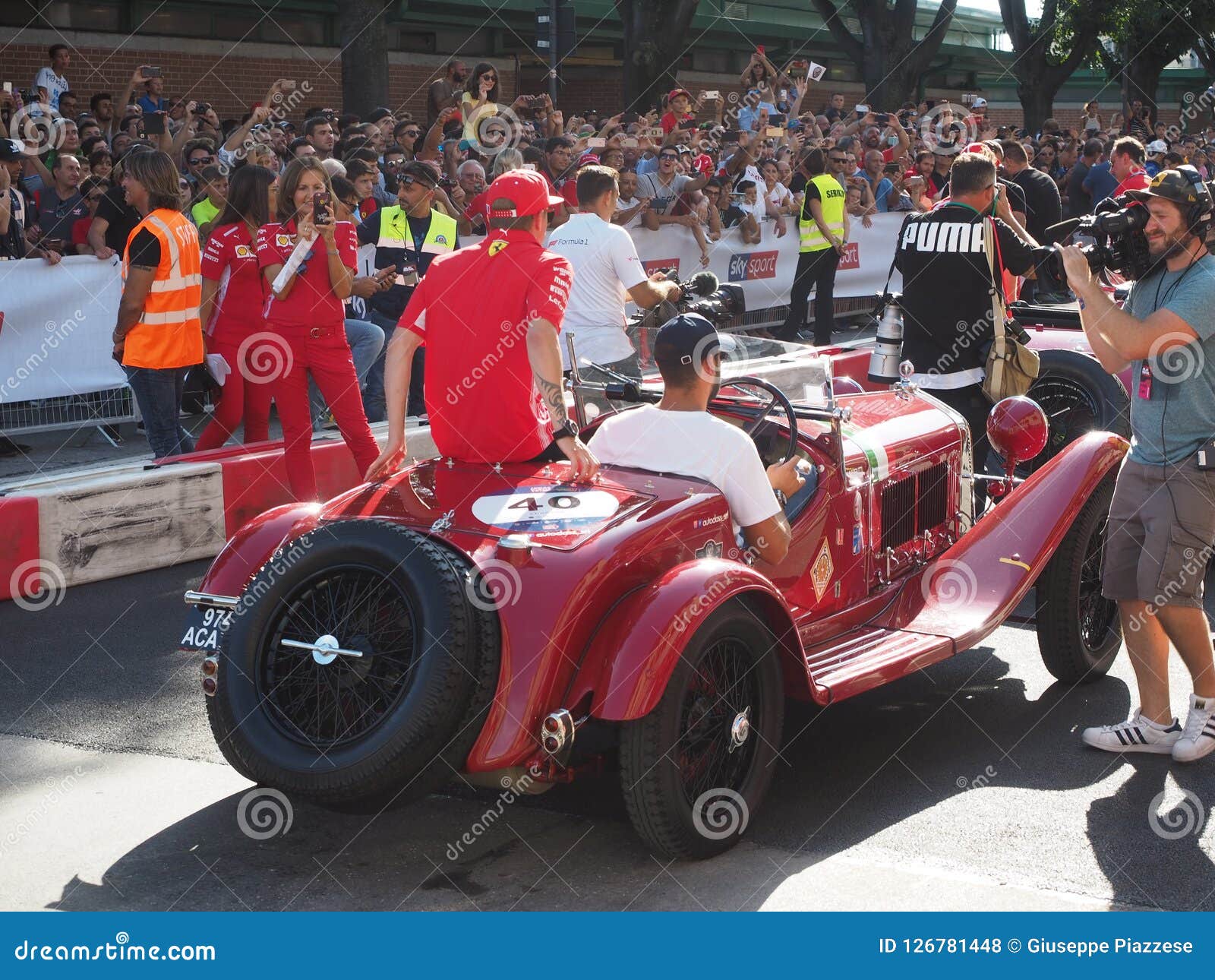 Milan Italien - Augusti 29, 2018: Utställning på formeln 1 dag i det Milan centret, med den Ferrari Vettel, Raikkonen och Sauber alfabetisken Romeo Leclerc, Ericsson som kör bilen f1 mellan gatorna