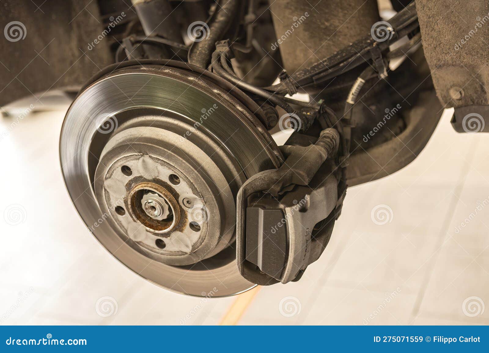 Routine Maintenance on the Brakes of a MercedesBenz Car in a Garage