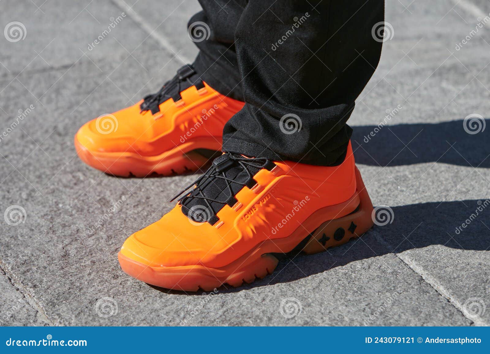 Man with Orange and Black Louis Vuitton Sneakers before Marco