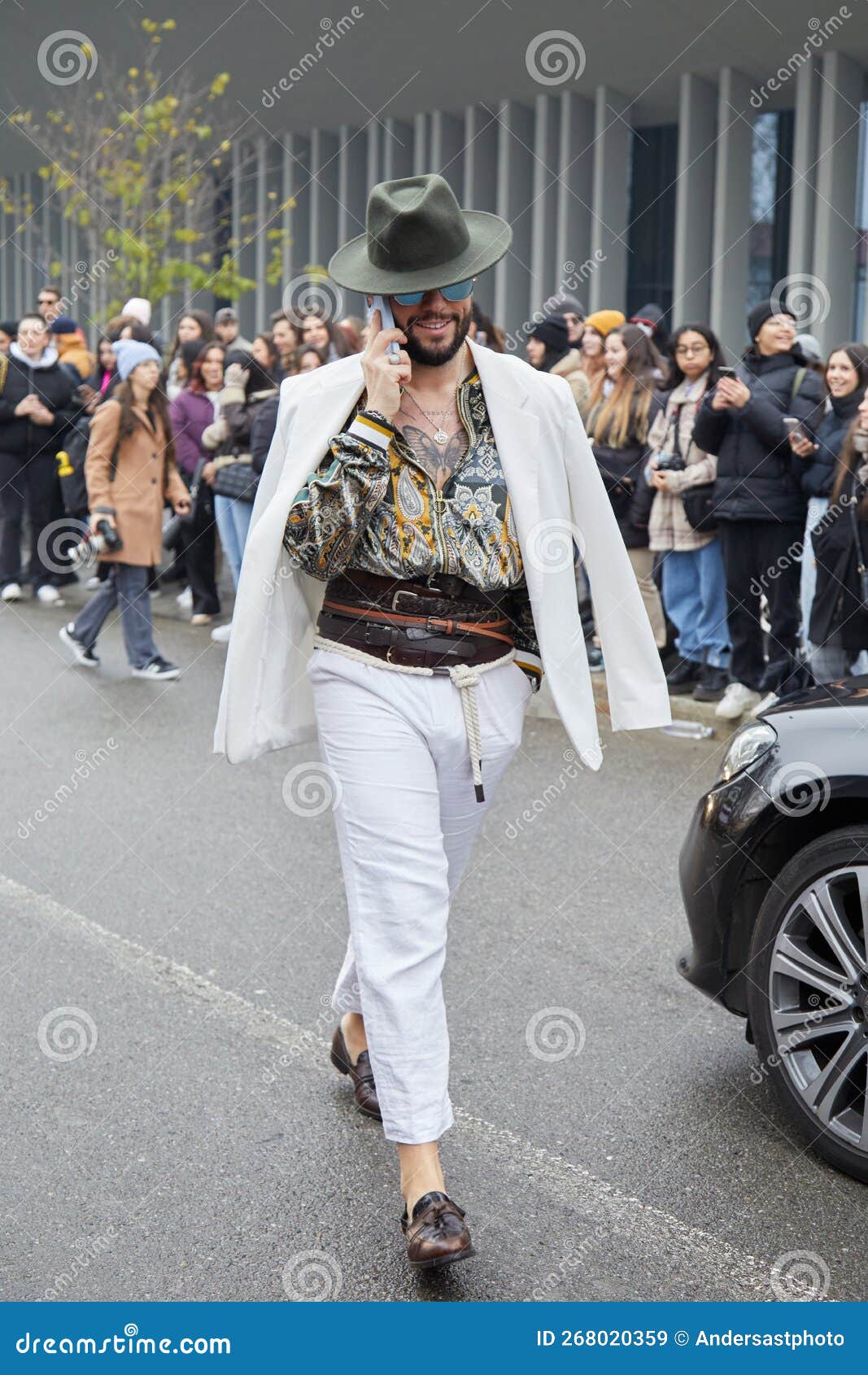 Man with White Jacket and Trousers and Olive Green Hat before Etro