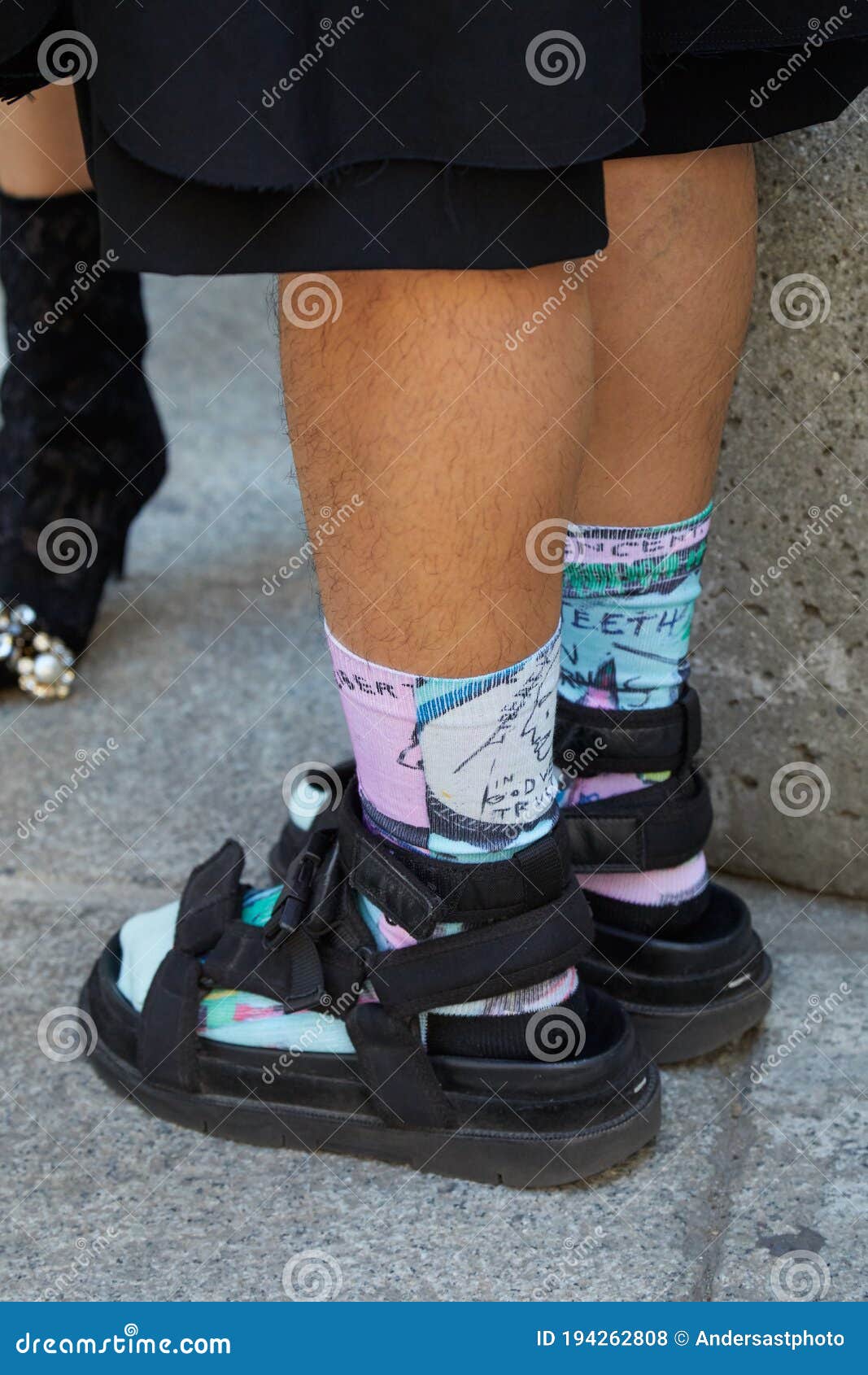 Man with Black Sandals with Purple and Turquoise Socks before Les ...