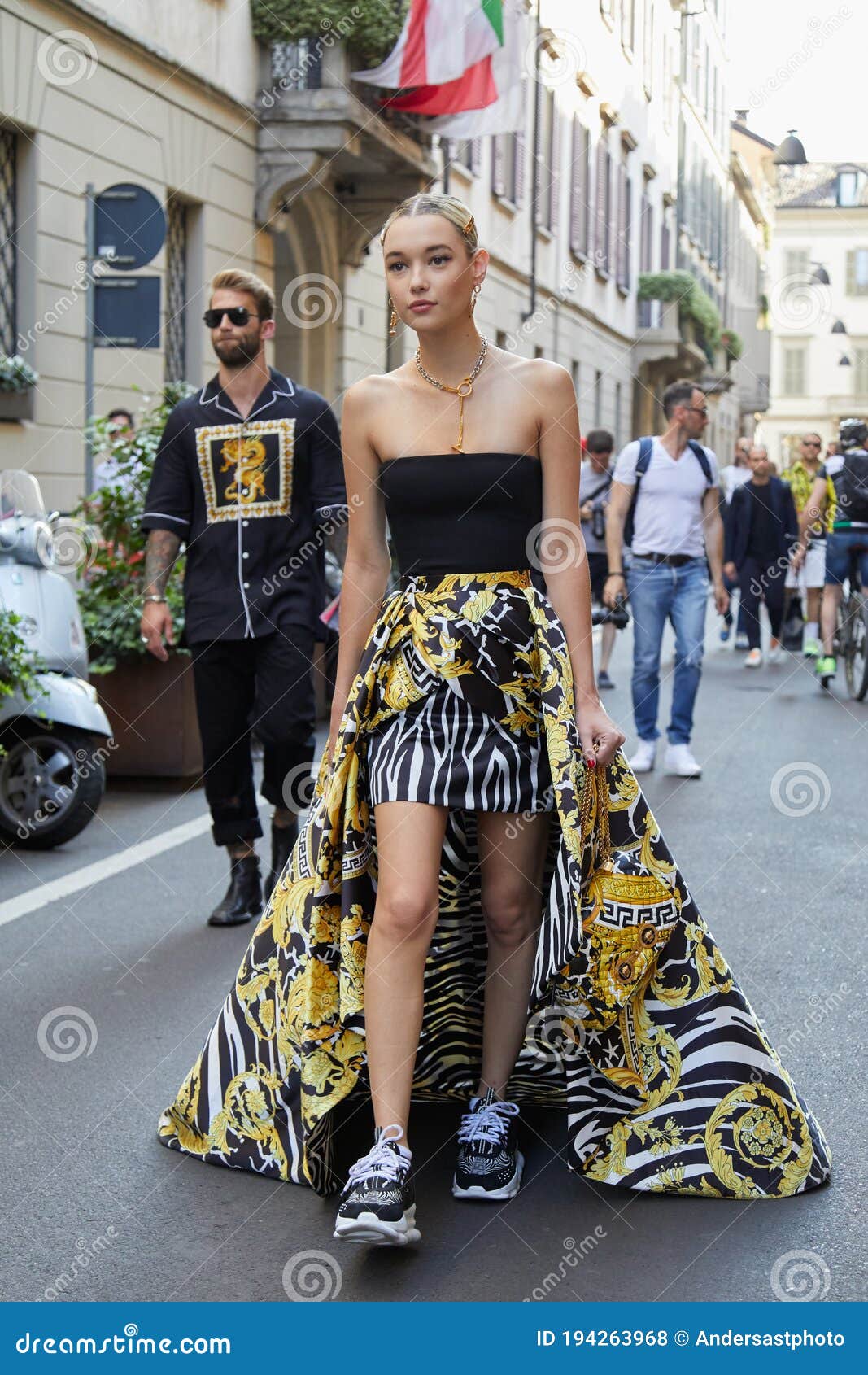 Woman with Versace Skirt with Golden, Black and White Design