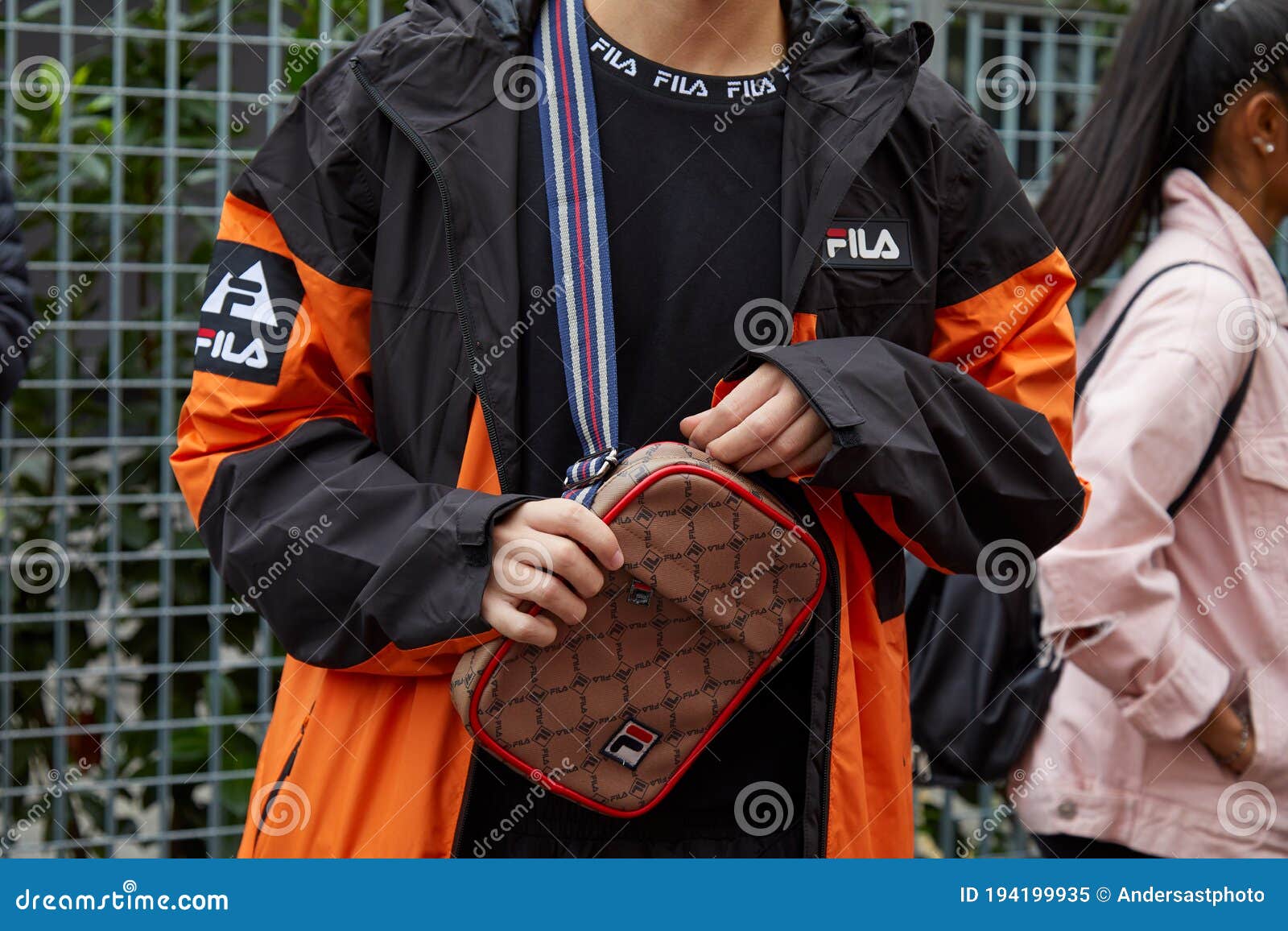 Man with and Orange Fila Jacket and Brown and Red Bag before Fila Fashion Show, Milan Editorial - Image of color, style: 194199935