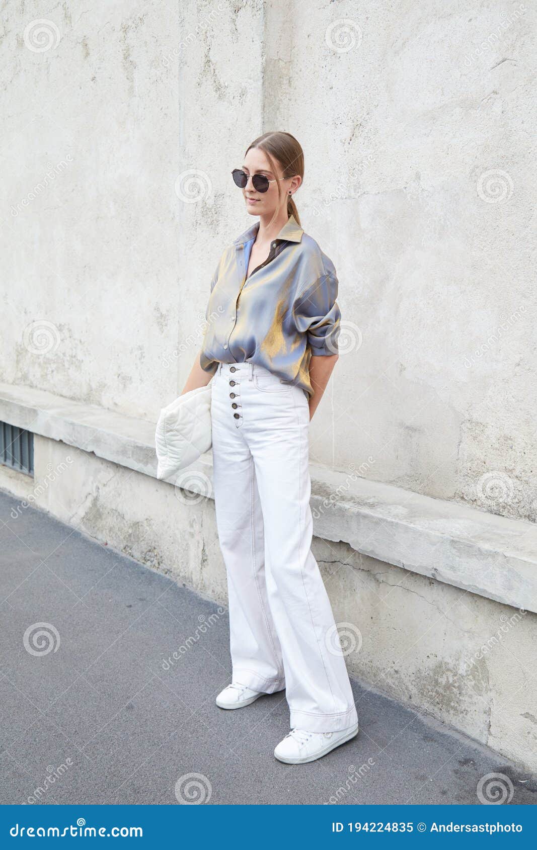 Woman with Gray and Golden Silk Shirt and White Trousers before
