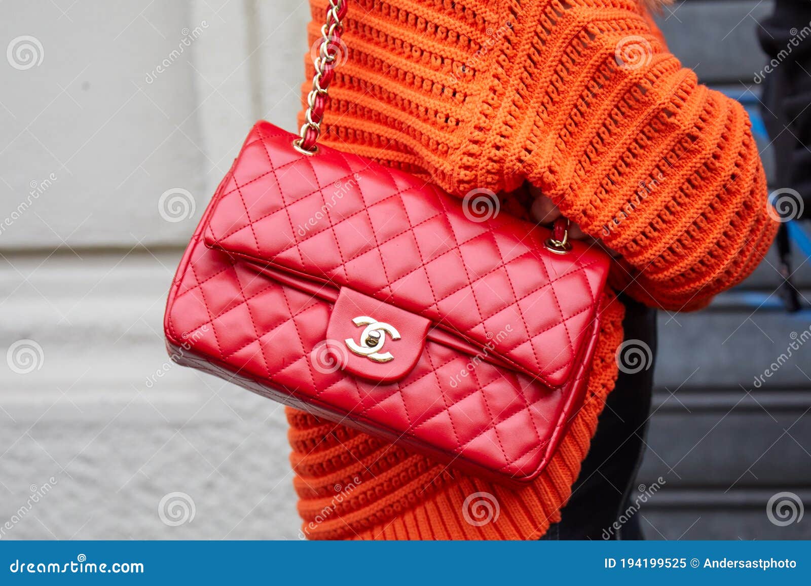 Woman with Red Leather Chanel Bag and Orange Sweater before Boss