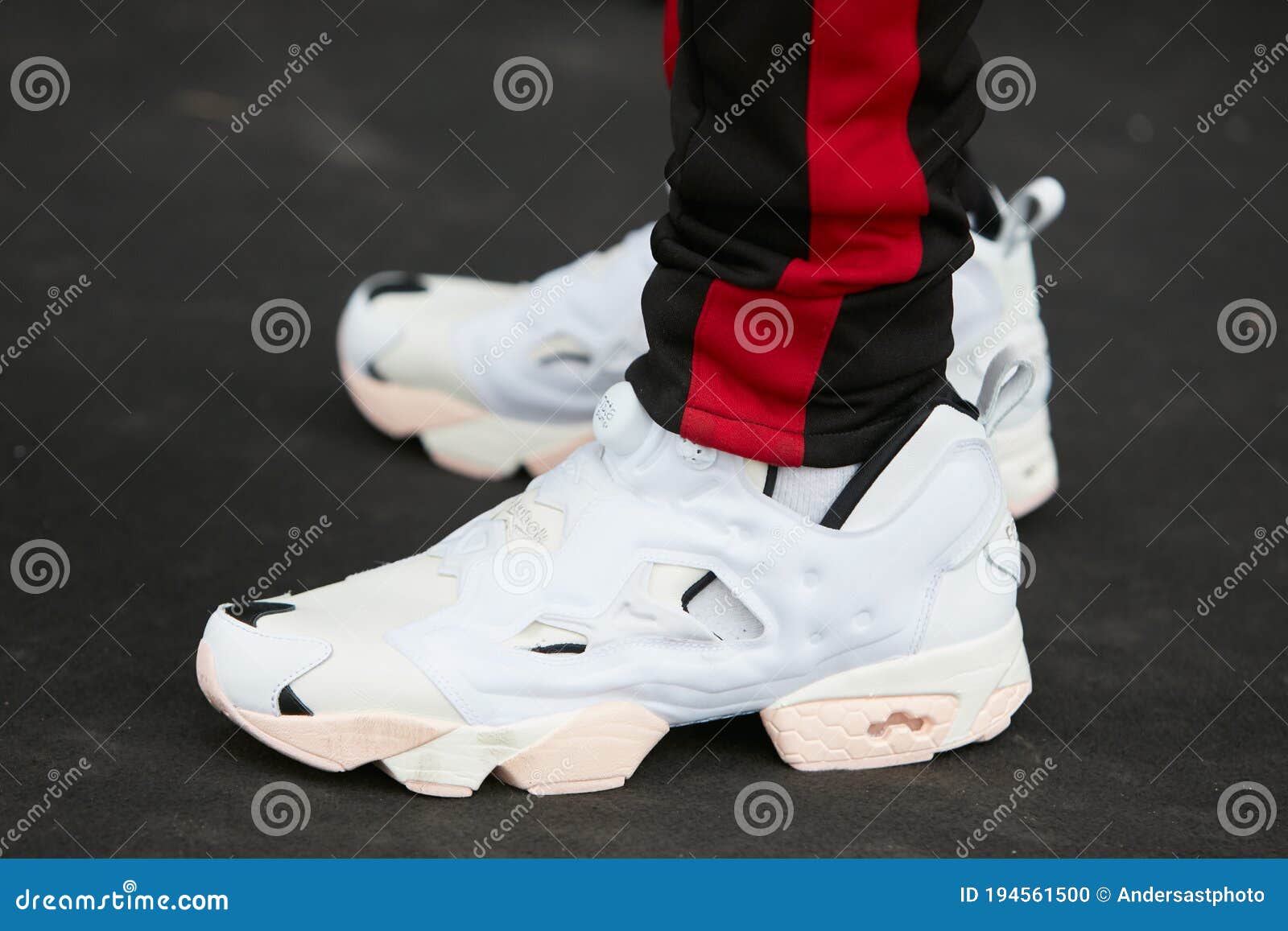 Man with White Reebok Insta Pump Shoes and Black Trousers with Red ...