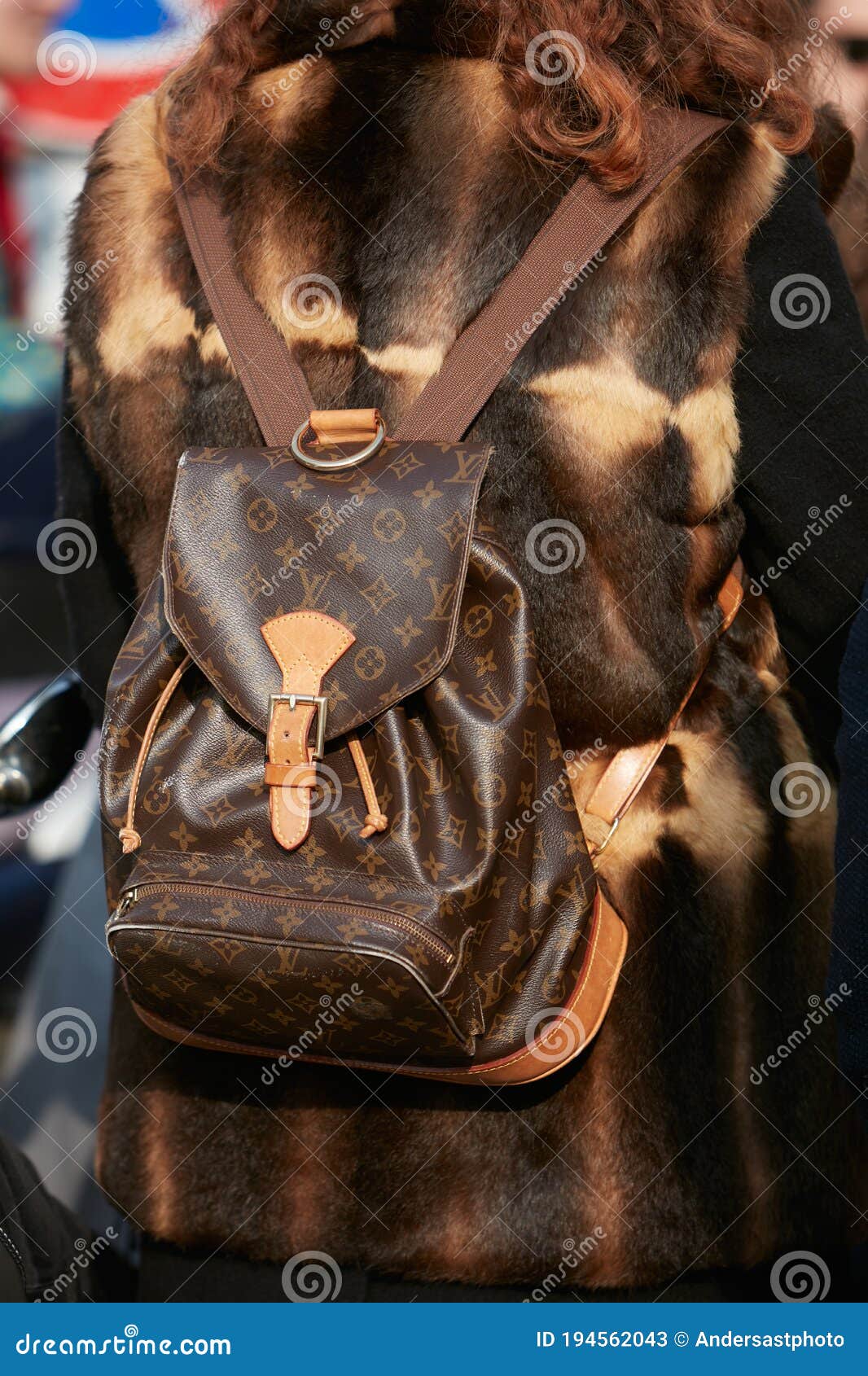 Woman with Louis Vuitton Backpack and Brown Fur Coat before