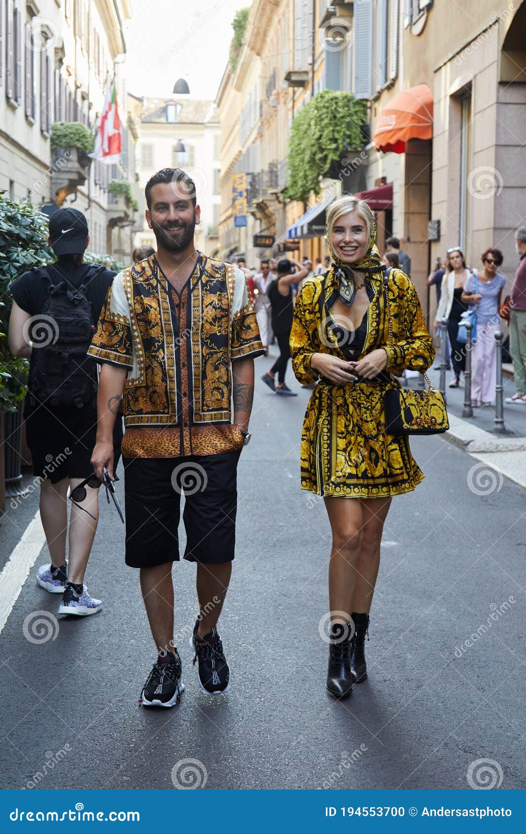 Man and Woman with Versace Clothing with Golden Designs before