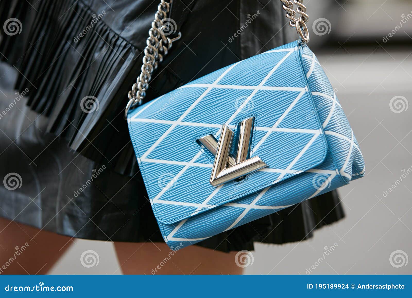 Woman with Louis Vuitton Pale Blue Bag before Max Mara Fashion