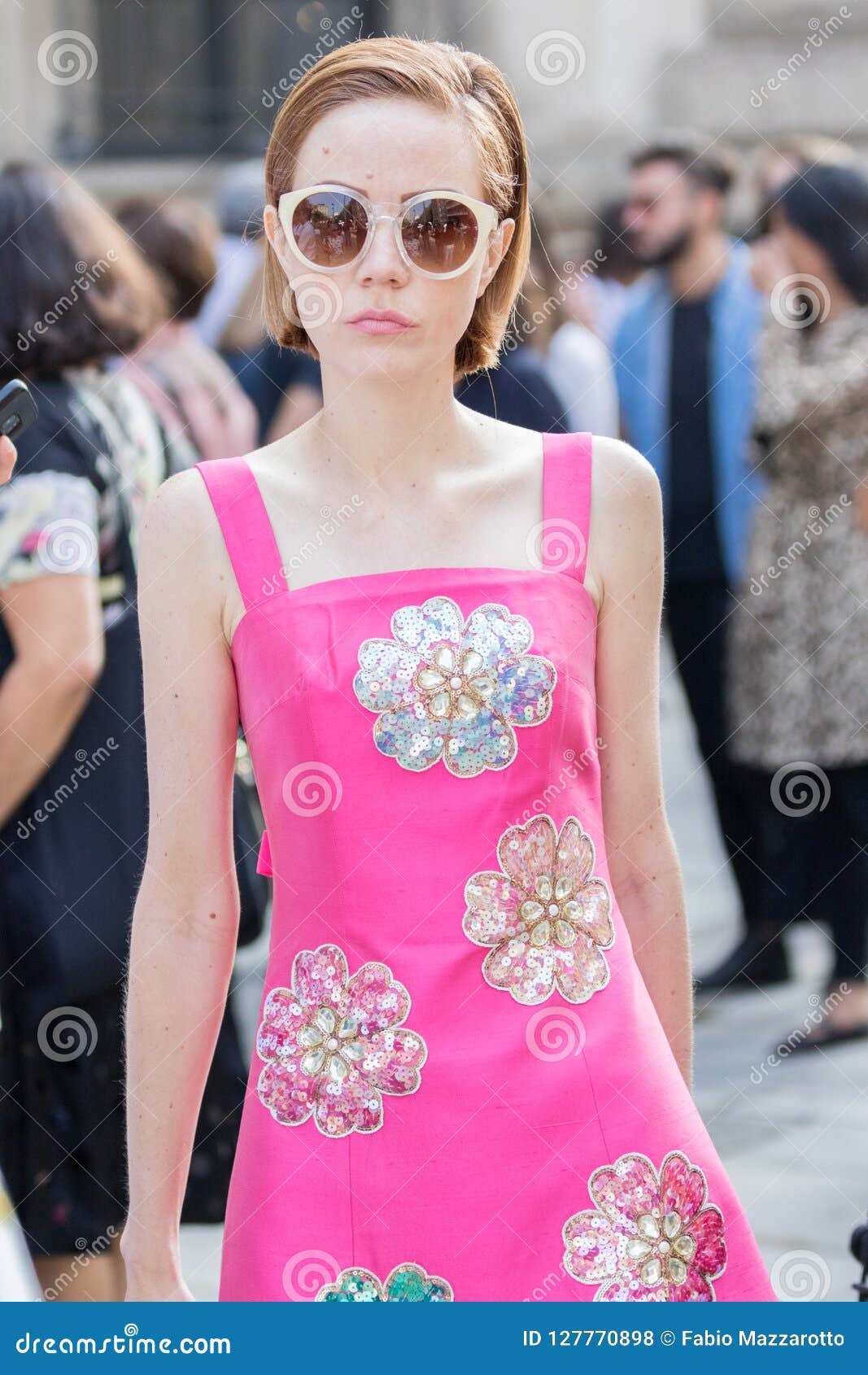 Woman with pink and brown Louis Vuitton bag and pink suit on February 25,  2016 in Milan, Italy Stock Photo