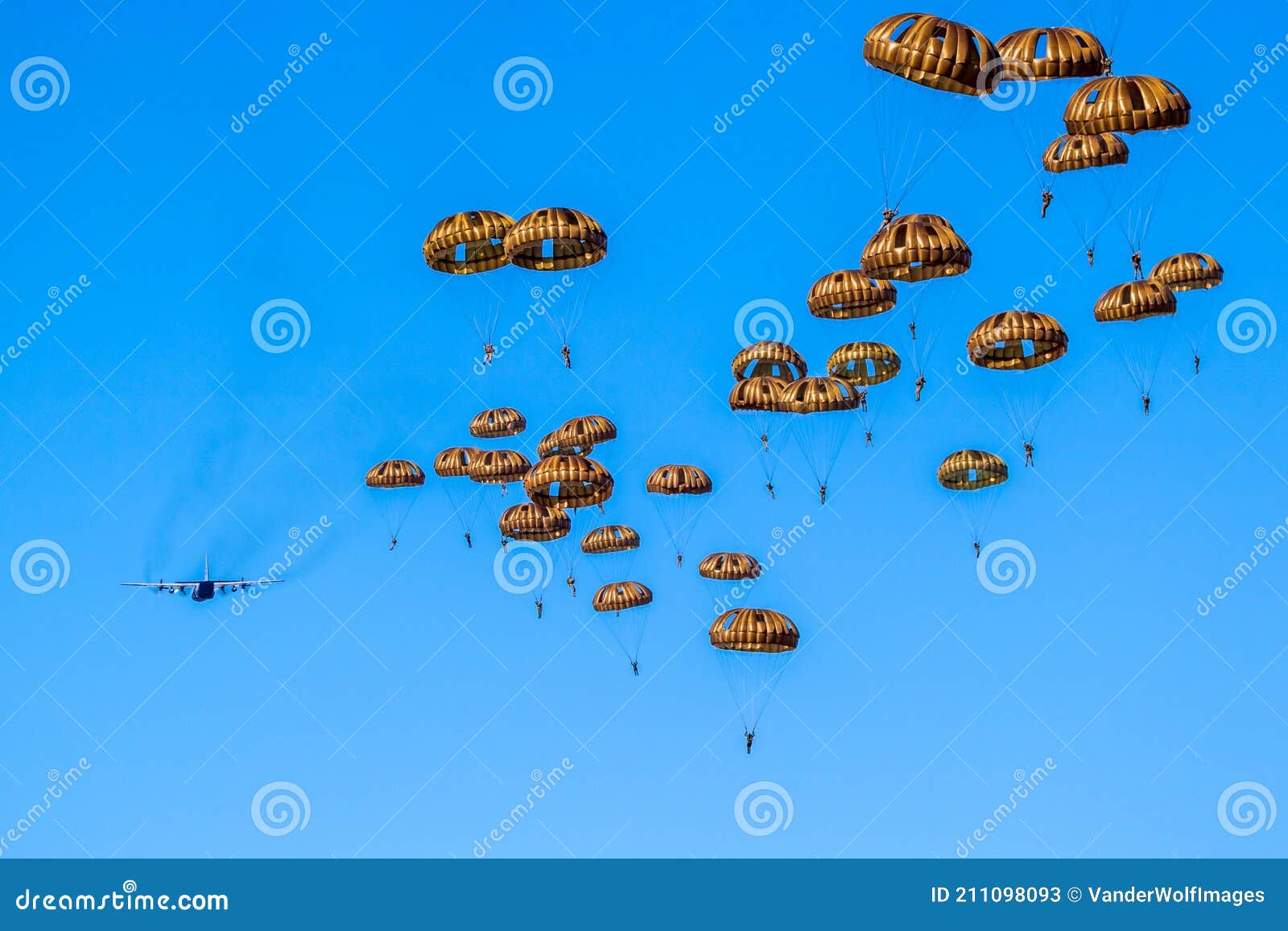 military parachutist paratroopers parachute jumping out of a air force planes on a clear blue sky day