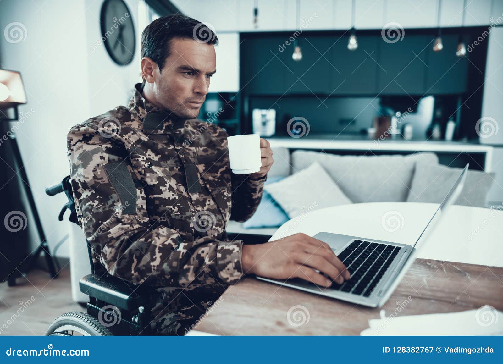 Military In Wheelchair Work On Laptop And Drinks Stock Image