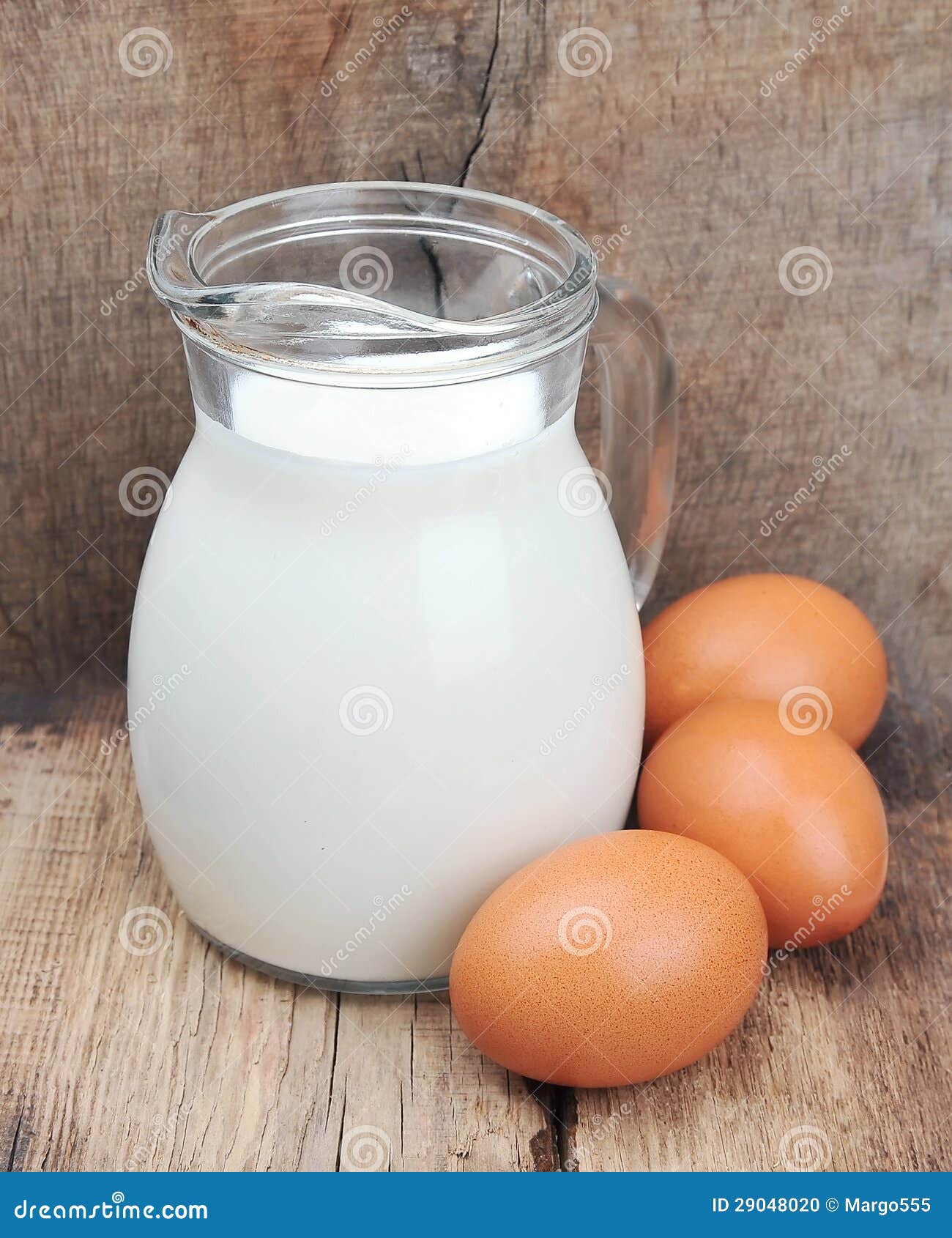 Jug With Milk And Two Eggs On White Background RoyaltyFree Stock Image