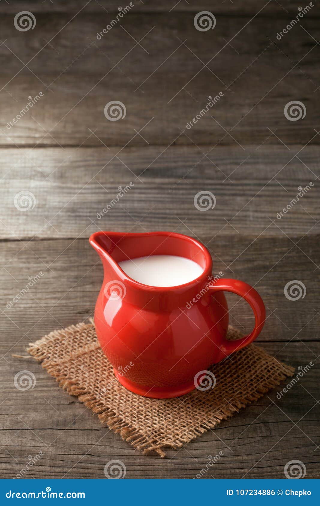 Milk In Glass Pitcher On Whit