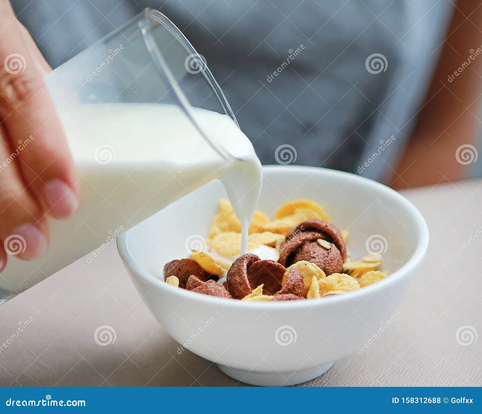 Milk Pouring into Bowl of Muesli on Table Stock Photo Image of fresh, cereal 158312688