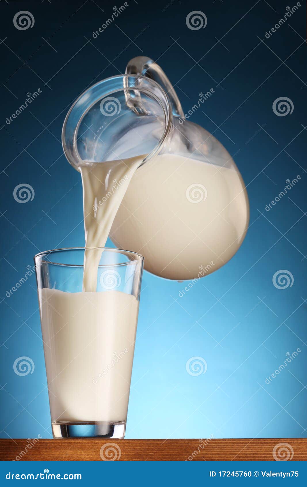 Milk Pouring from Jar into Glass. Stock Photo Image of studio, dairy