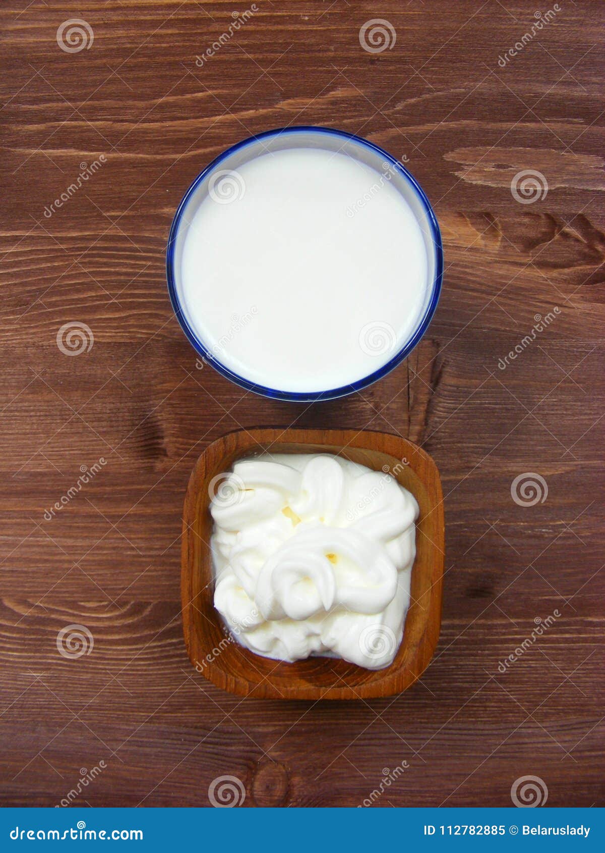 Milk And Sour Cream In Wooden Bowl On Wooden Table Vertical Flat