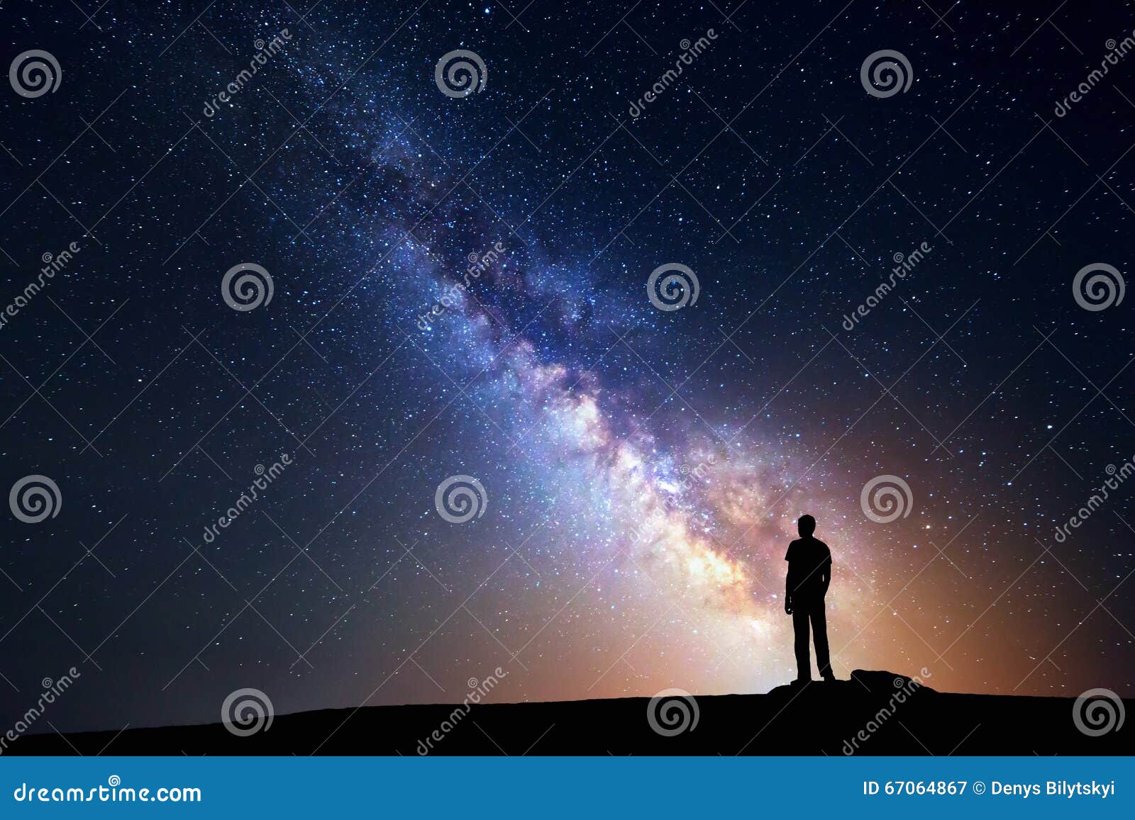 milky way. night sky and silhouette of a standing man