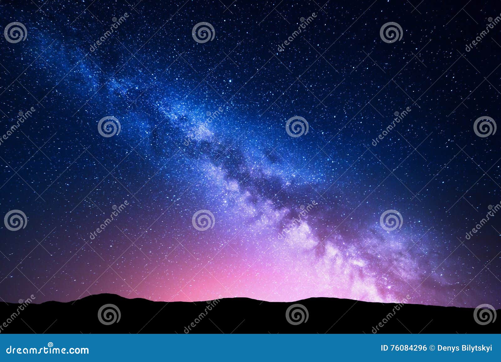 milky way and pink light at mountains. night colorful landscape.