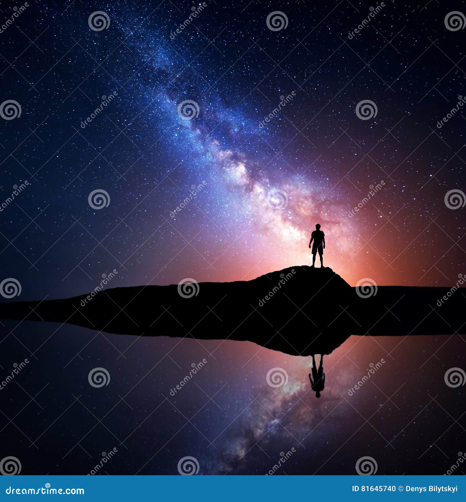 milky way and silhouette of a standing alone man