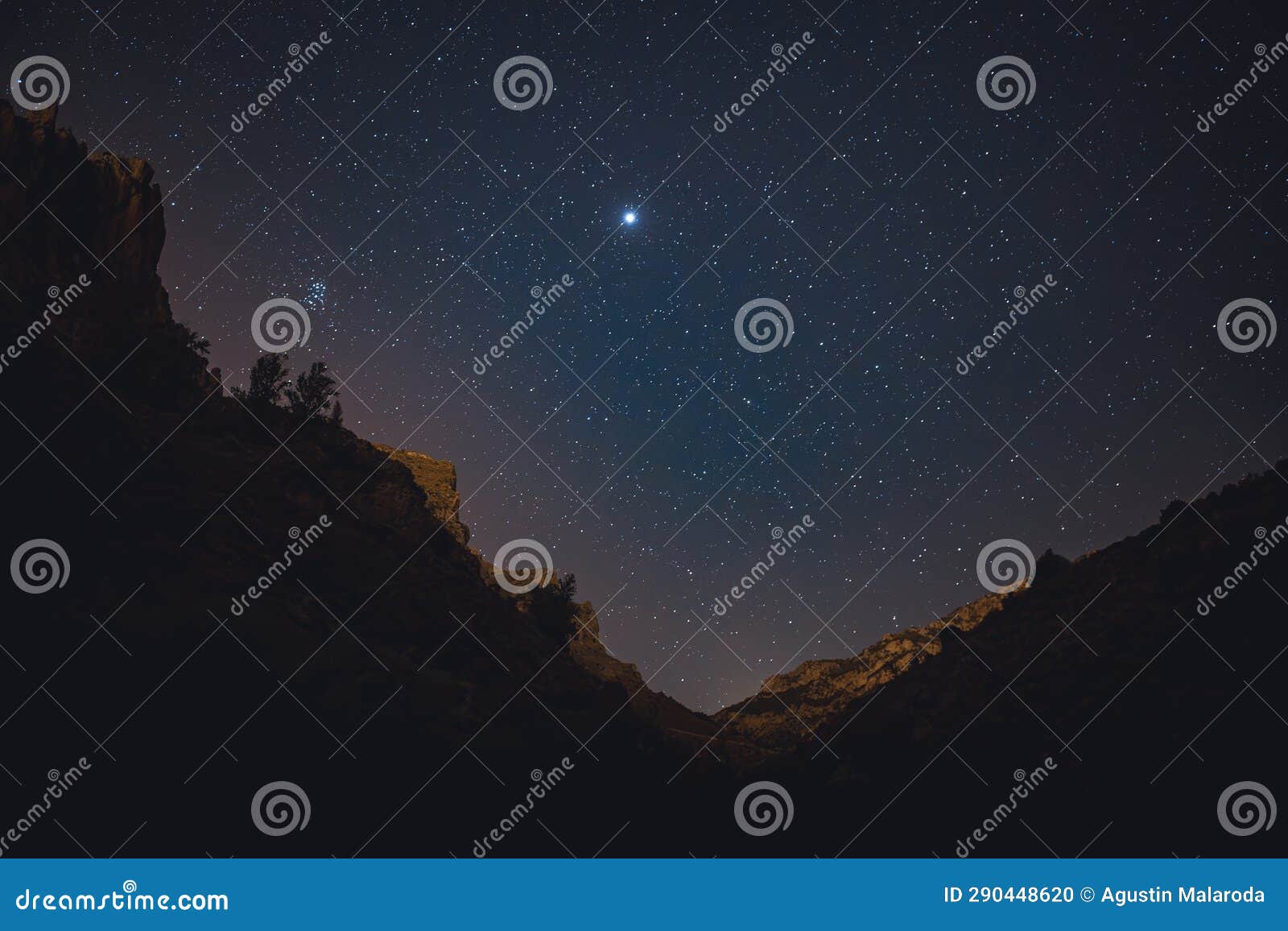 milky way in the starry night between mountains with meteor shower