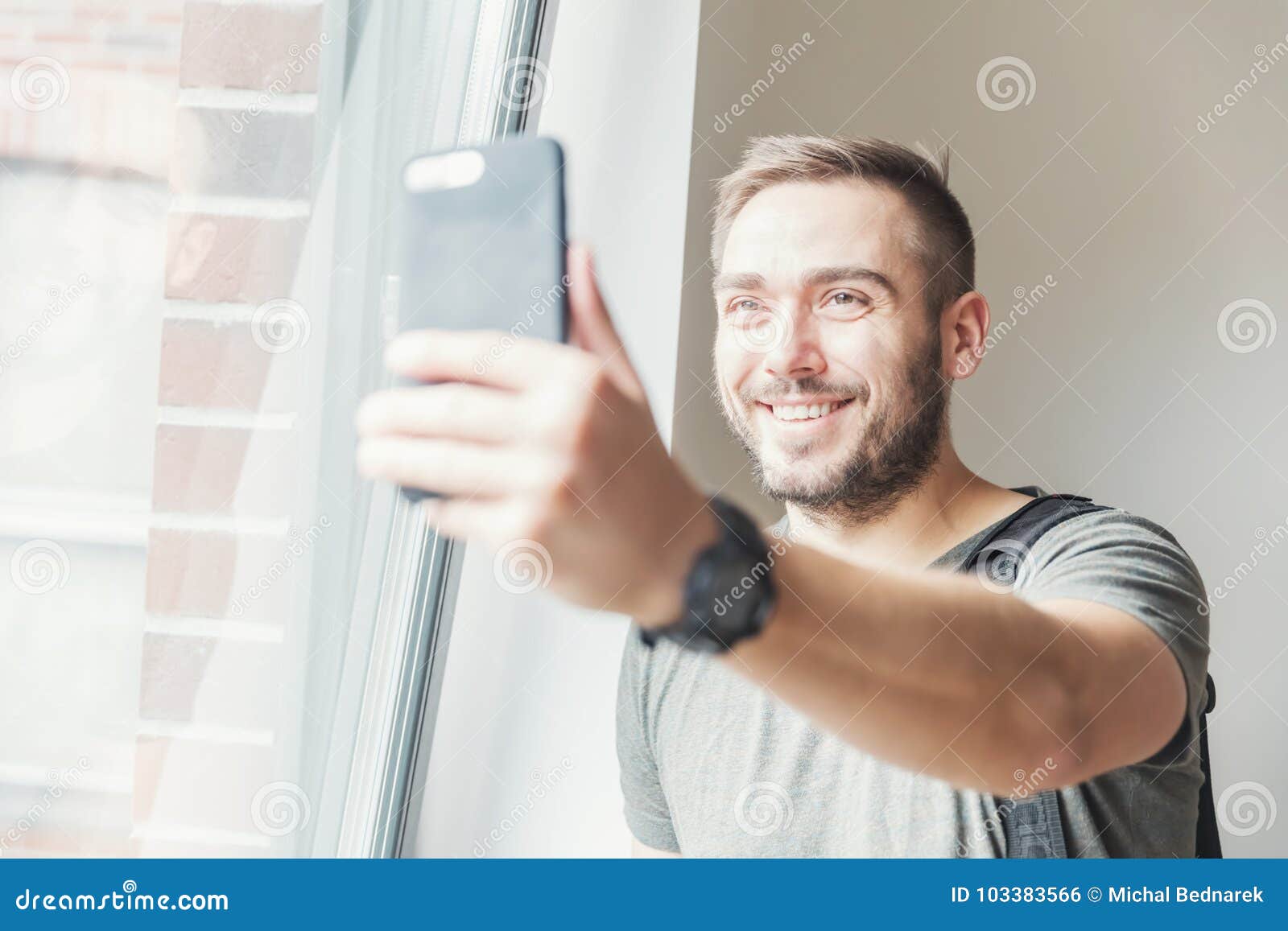 millenial man taking a selfie.