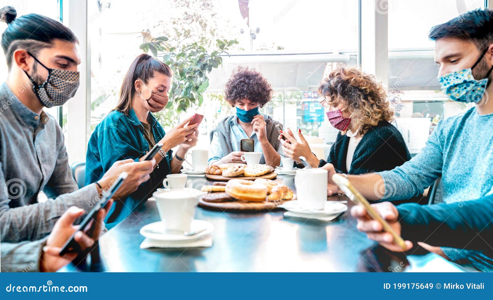 millenial people using mobile smart phones at coffee bar - new normal lifestyle concept with friends checking contact tracing app