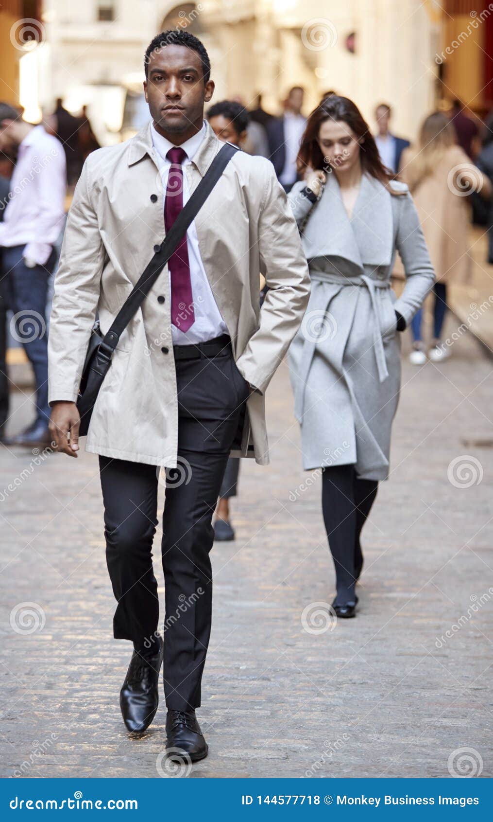 Millennial Black Businessman Walking in a City Street Looking To Camera ...
