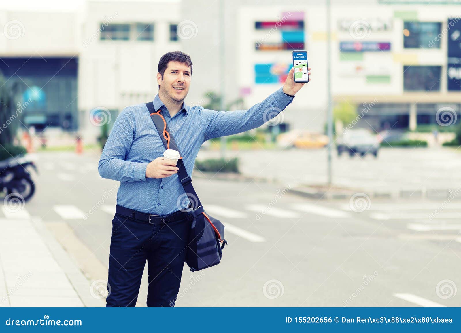 millennial business man with hand up calling taxi or ride share car hailing from sidewalk