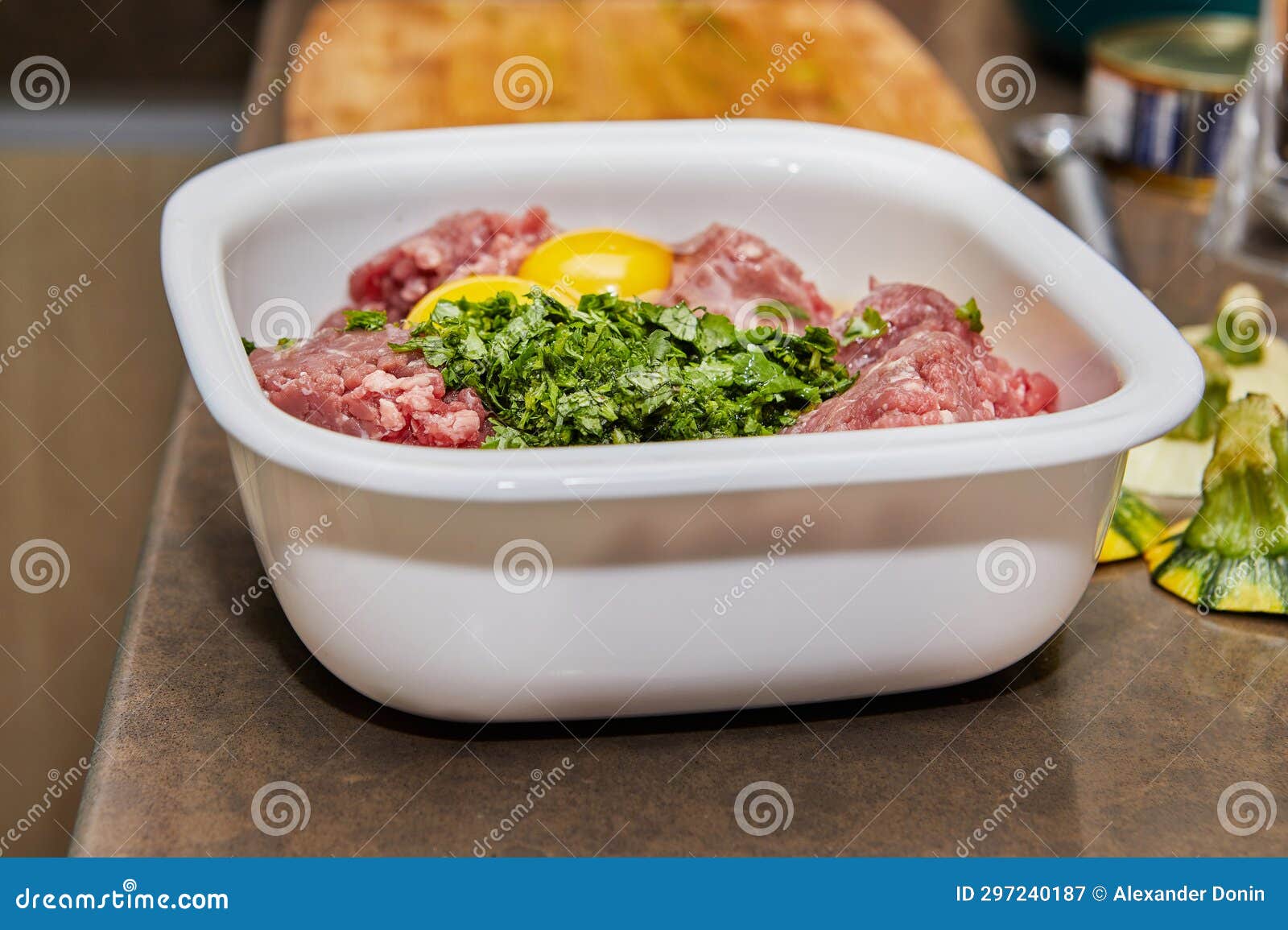 minced meat with eggs and herbs in bowl