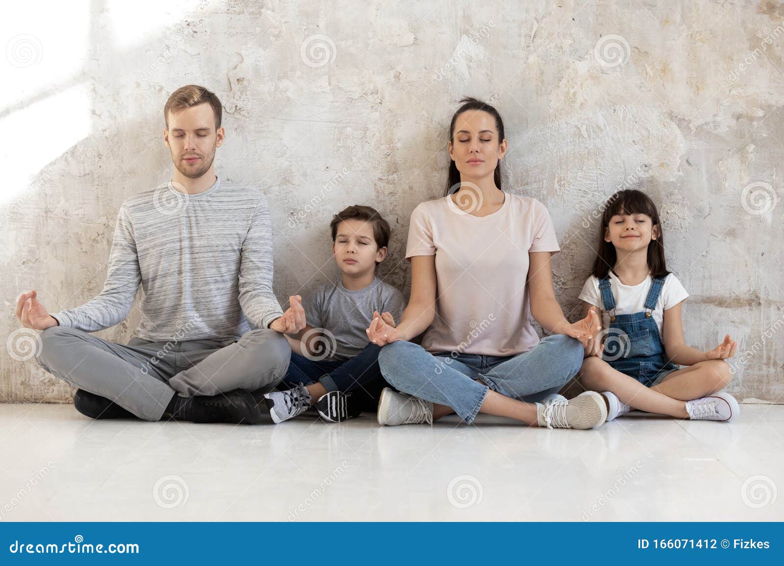 mindful calm happy family of young parents and little kids.