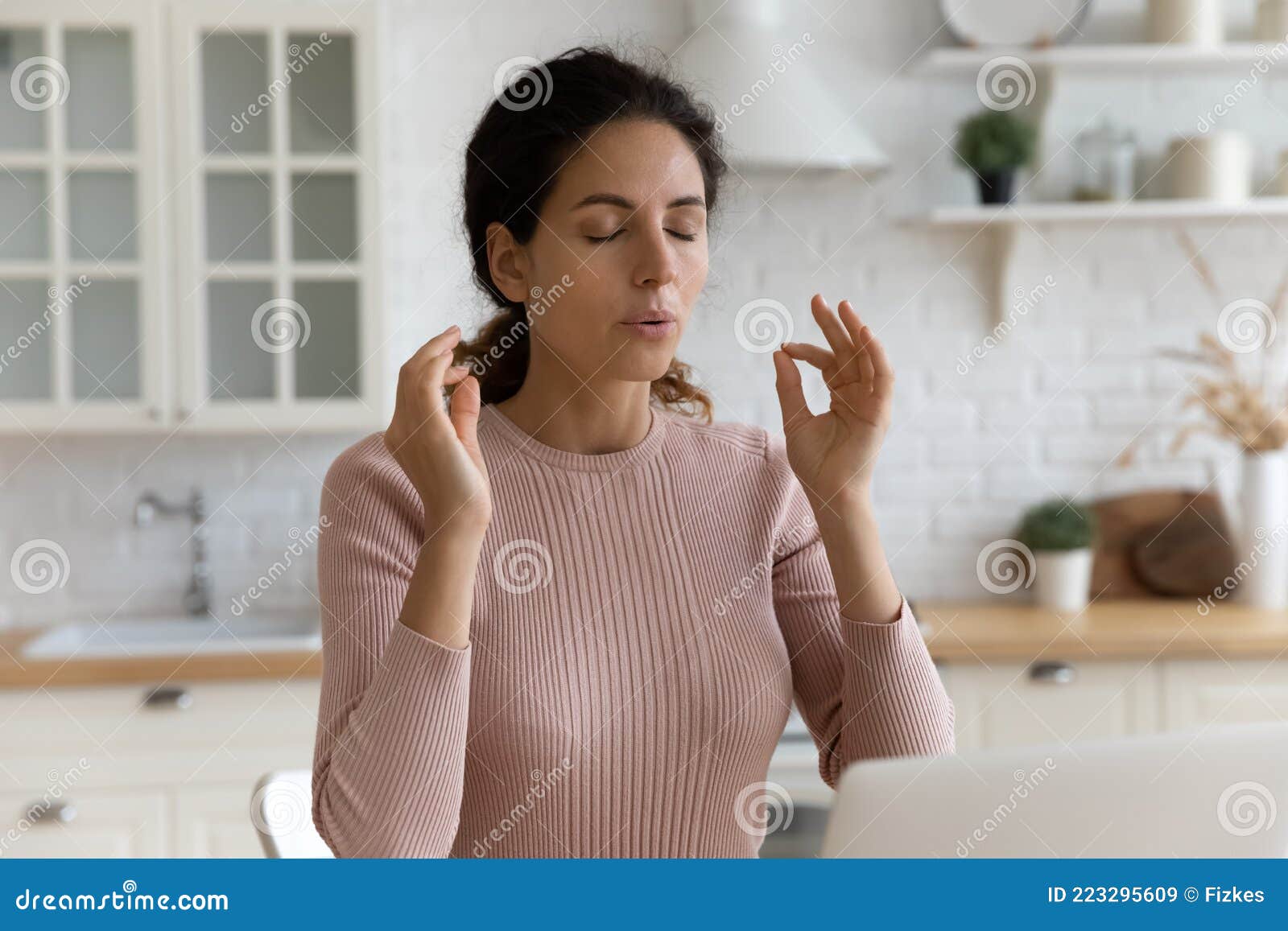 mindful young woman calming down in stressful situation.