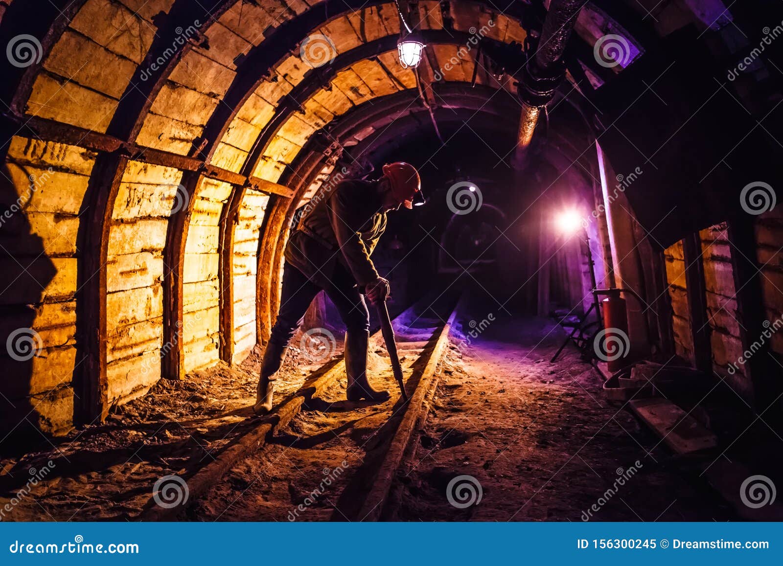 miner working a jackhammer in a coal mine. work in a coal mine. portrait of a miner.