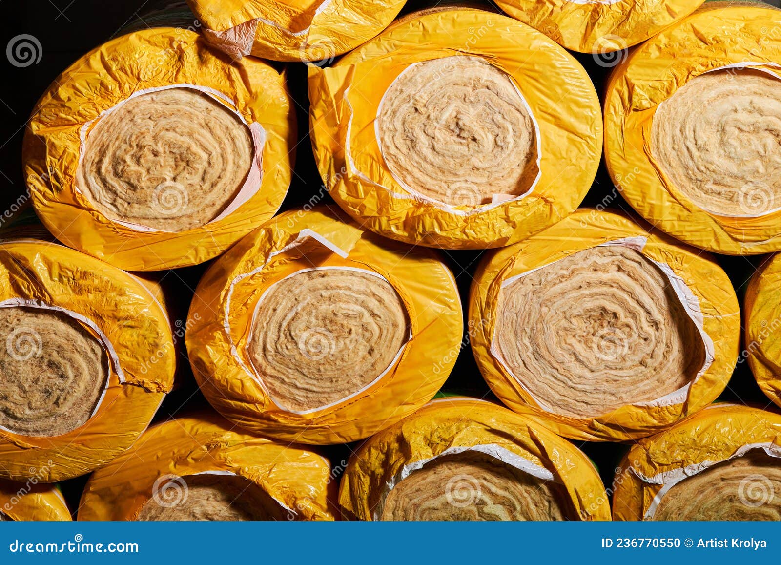 Mineral Wool Insulation Rolls in Yellow Packaging Close Up. Stock Photo