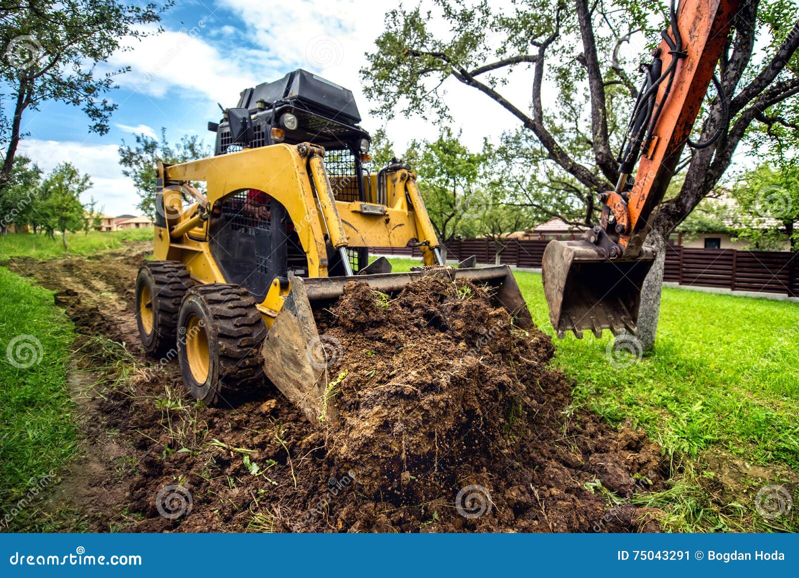 mini bulldozer working with earth, moving soil and doing landscaping works