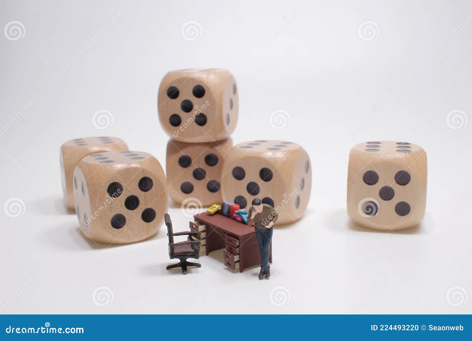 Mini Business People with Dice and Talking the Phone Stock Photo